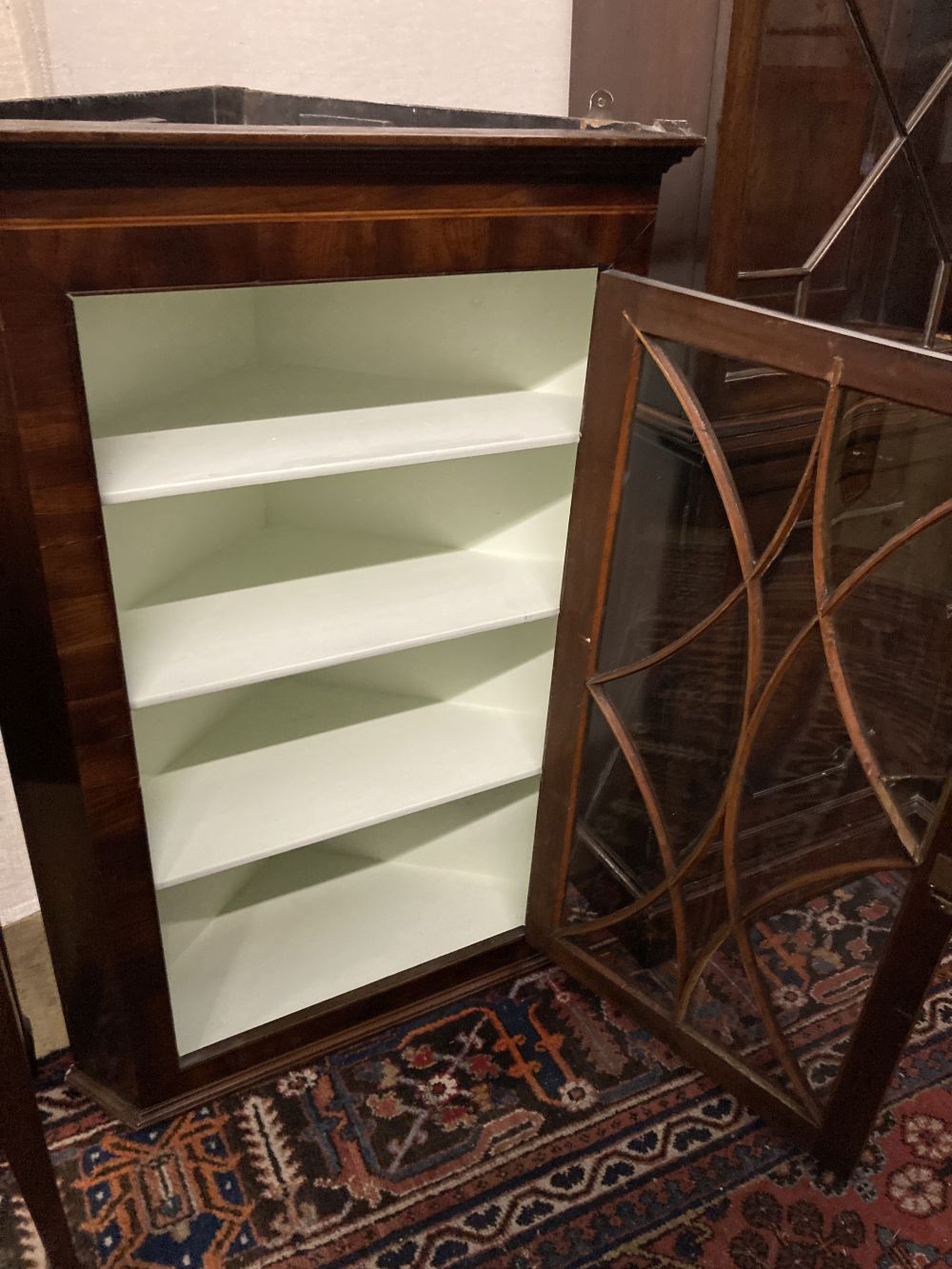 A George III mahogany hanging corner cupboard with glazed door, width 74cm, depth 39cm, height 110cm